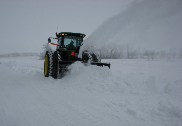 Black Max Heavy Duty Tractor Snow Blower removing a big pile of snow!